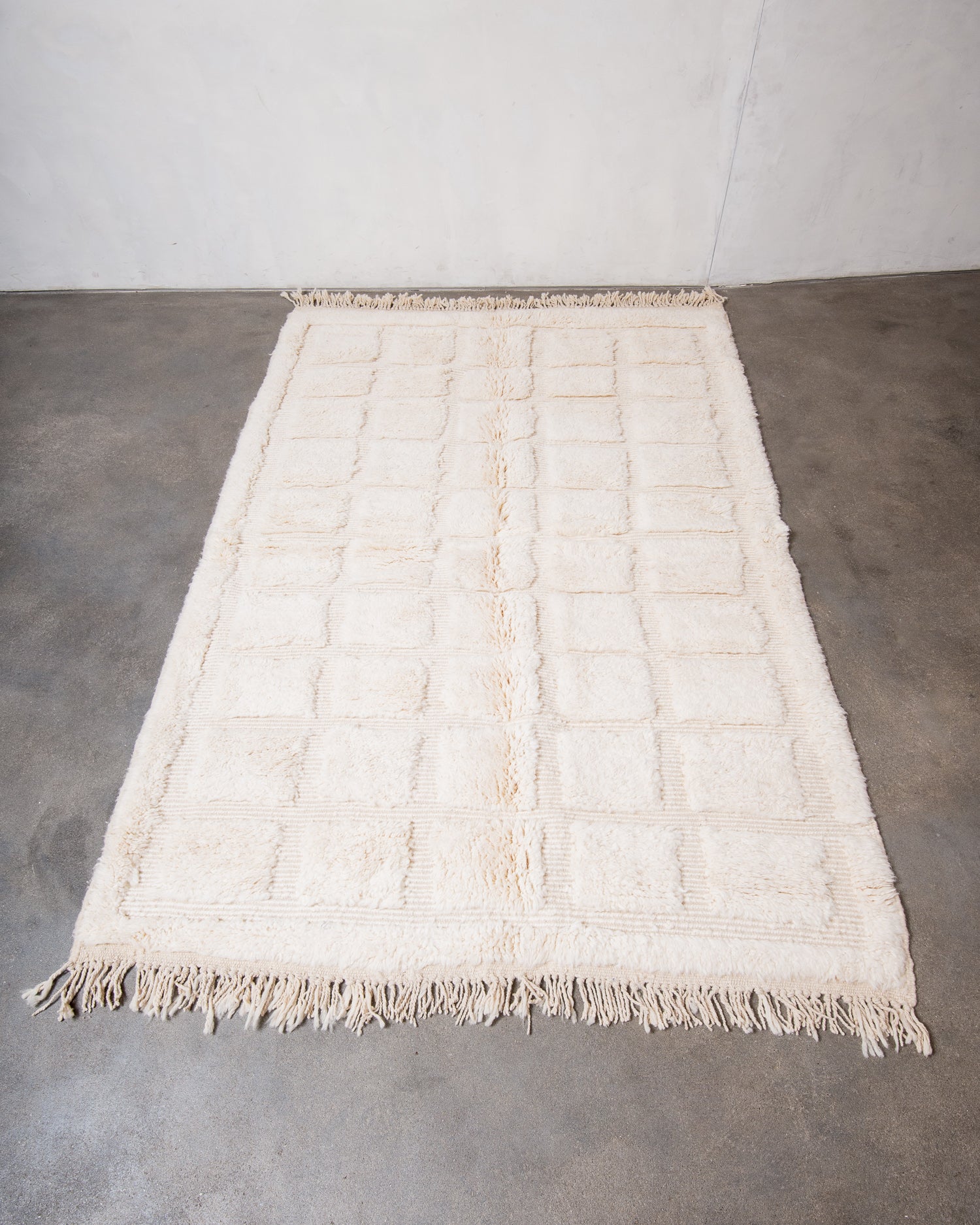 Modern, designer, handcrafted Berber rug from Morocco. Beniourain carpet with minimalist design, natural wool pile and a fluffy texture.